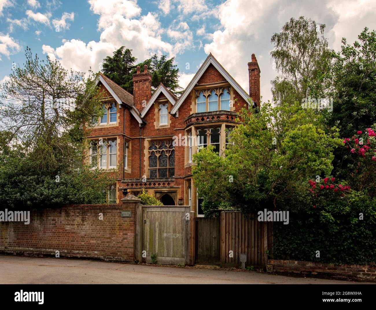 Large, well-appointed Victorian house on Banbury Road, North Oxford, behind brick wall and surrounded by trees Stock Photo