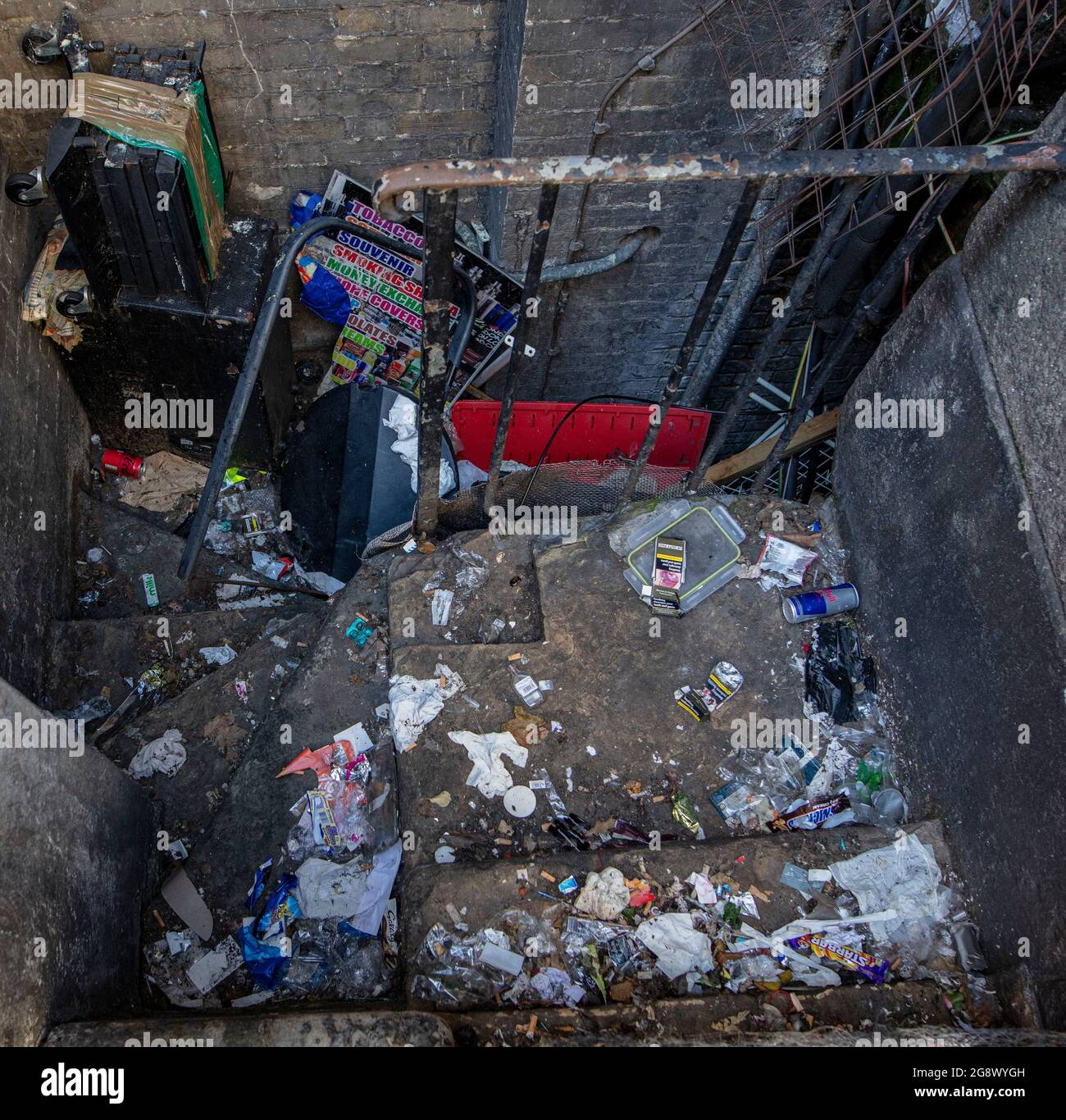Space between buildings in central London full of rubbish/garbage
