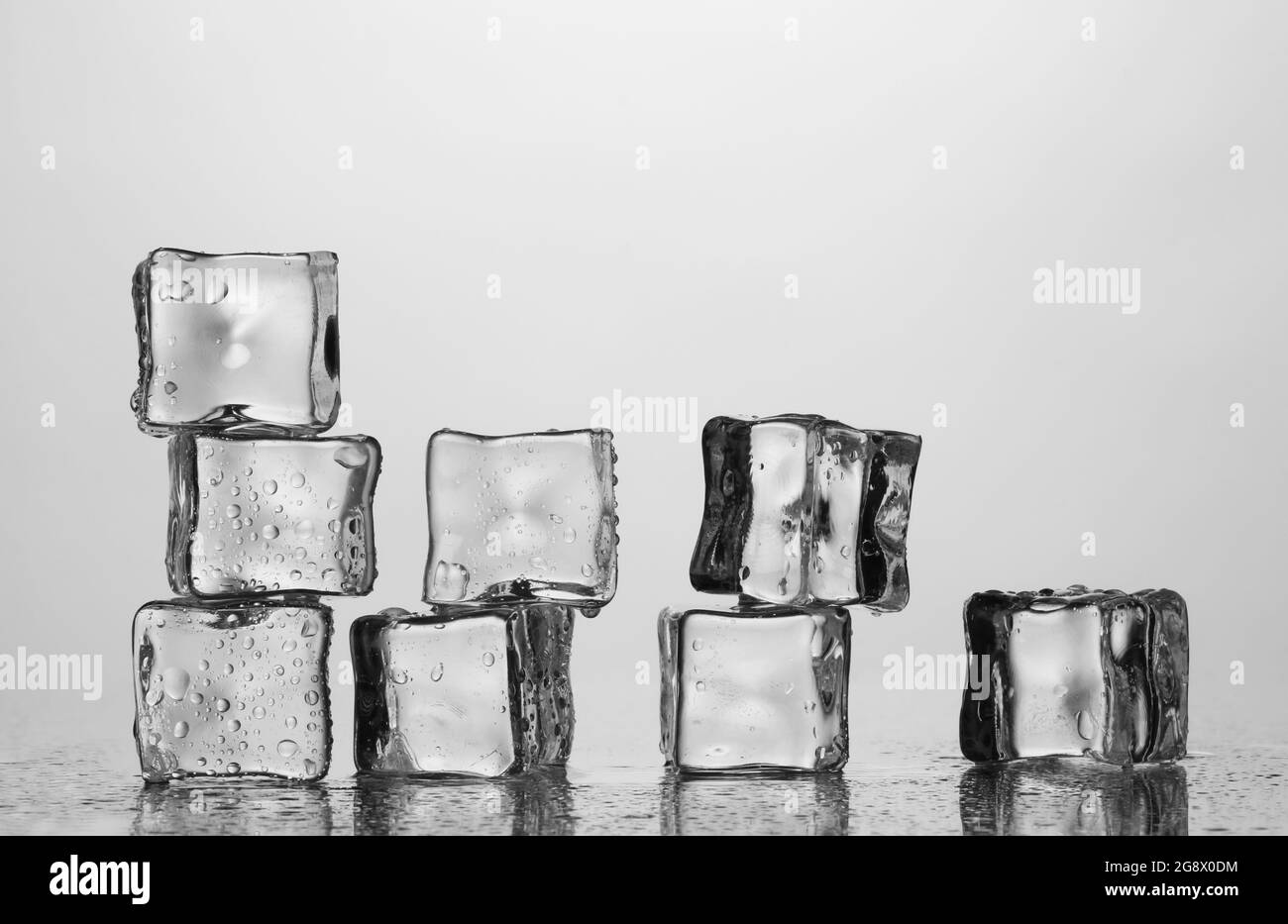 Melting ice cubes isolated on white Stock Photo - Alamy