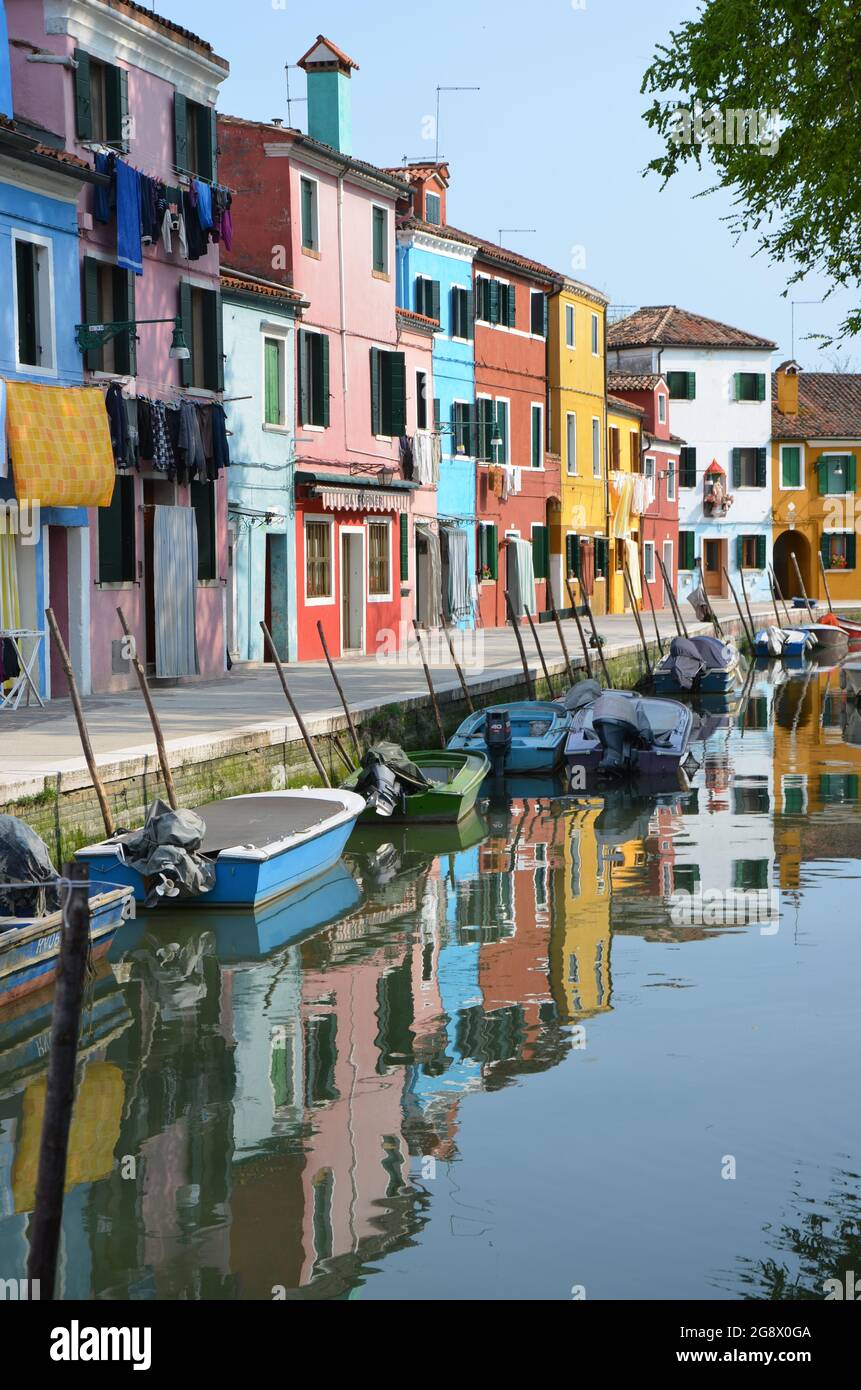 Small colorful houses from Burano in Venice, Italy, reflected in the