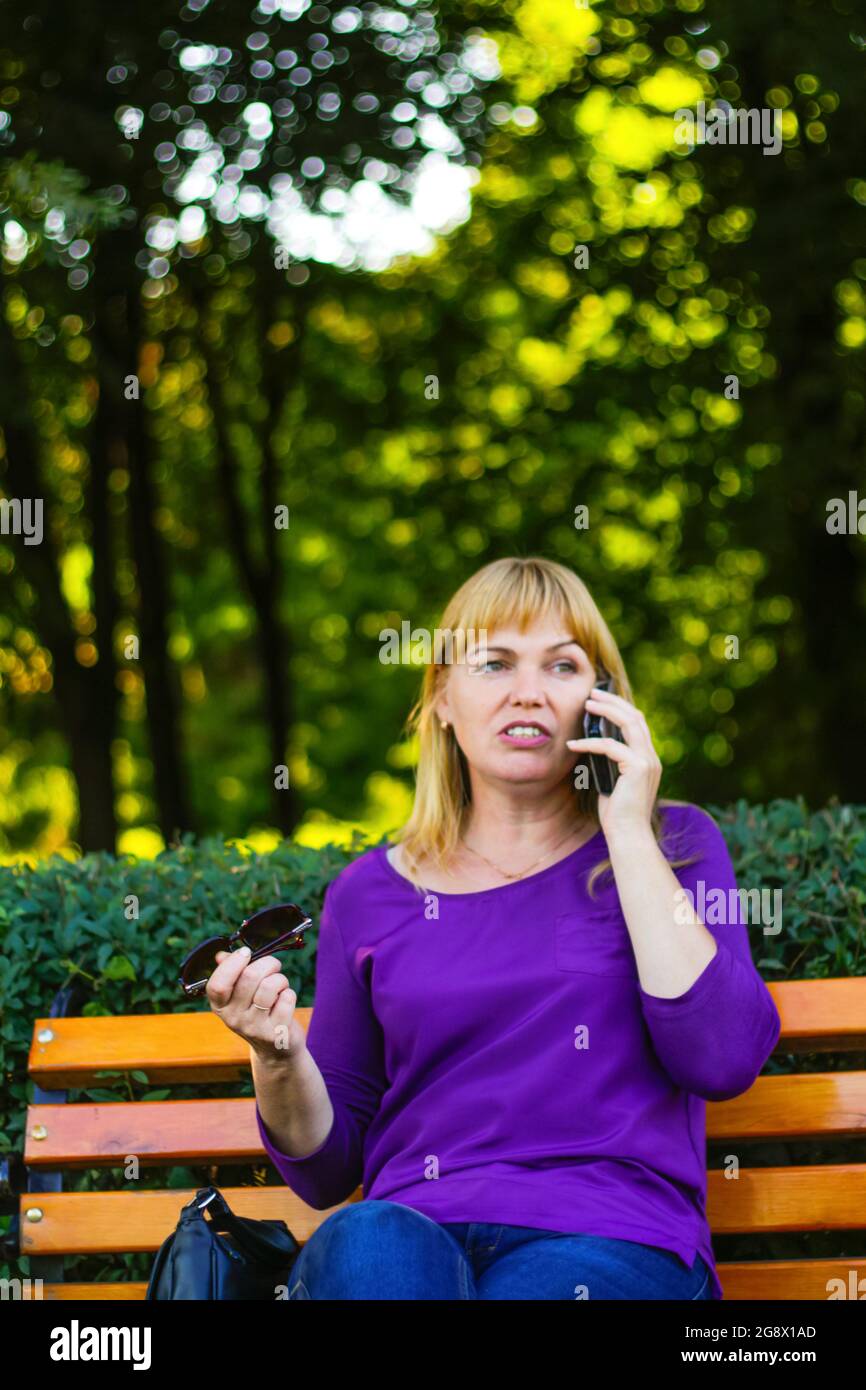 Defocus Caucasian Emotion Blond Woman Talking Speaking On The Phone Outside Outdoor 40s Years