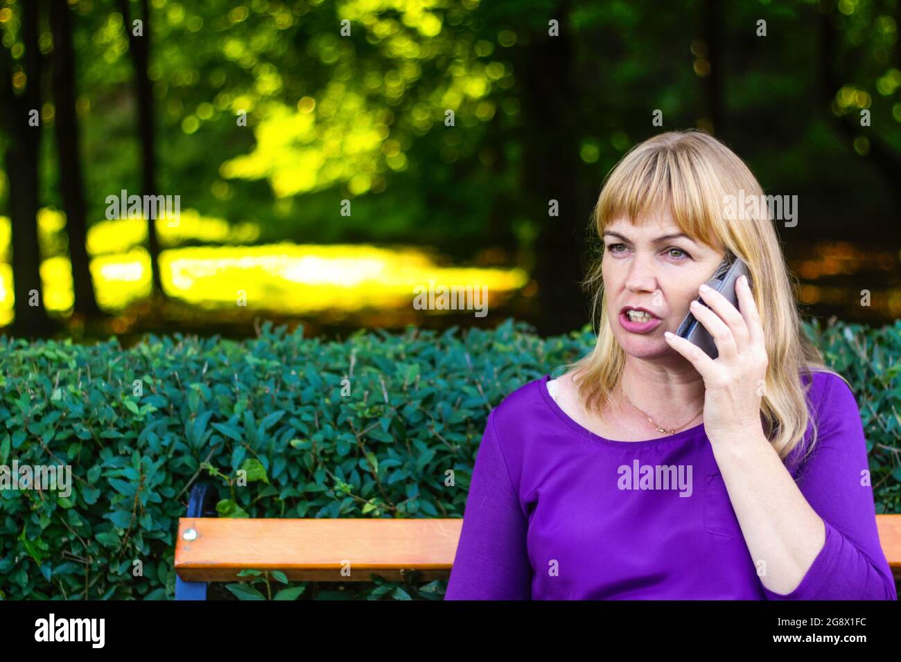 Defocus Angry Caucasian Blond Woman Talking Speaking On The Phone Outside Outdoor 40s Years