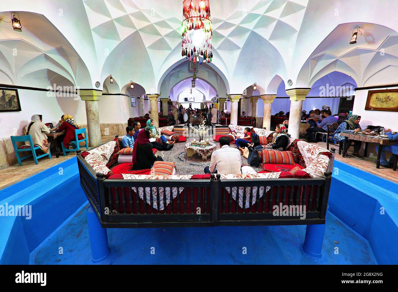 People eating in the restaurant converted from an historical bath in Kerman, Iran Stock Photo