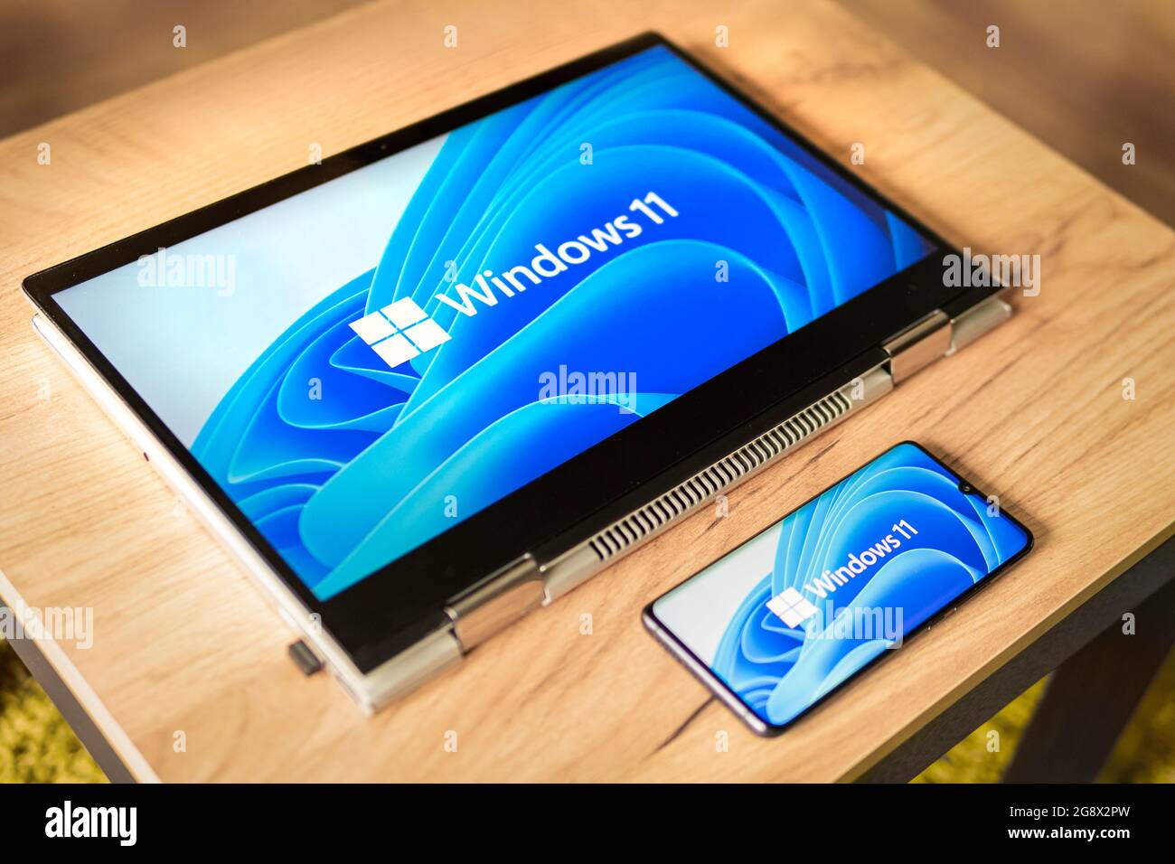 June 23, 2021. Barnaul, Russia. Windows 11 logo on the screens of a transformer laptop and a modern smartphone Stock Photo