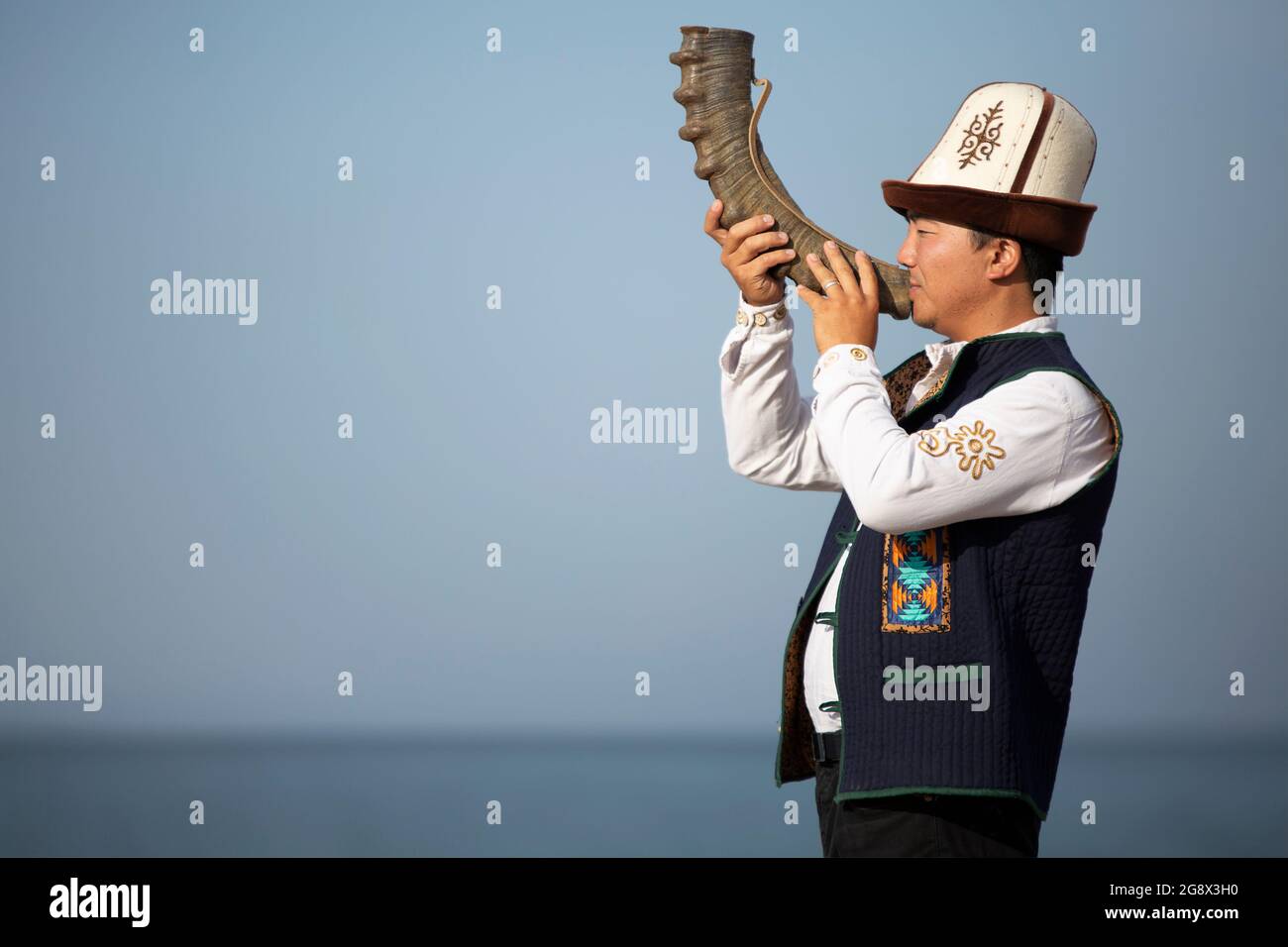 Kyrgyz musician playing local traditional instrument, in Issyk Kul, Kyrgyzstan. Stock Photo
