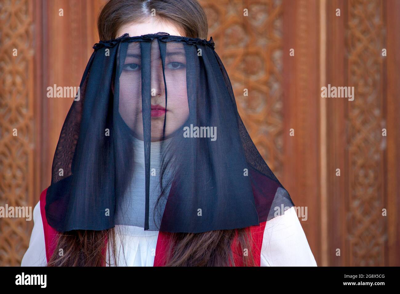 Portrait of Uzbek woman with veil on her face in Tashkent, Uzbekistan Stock Photo