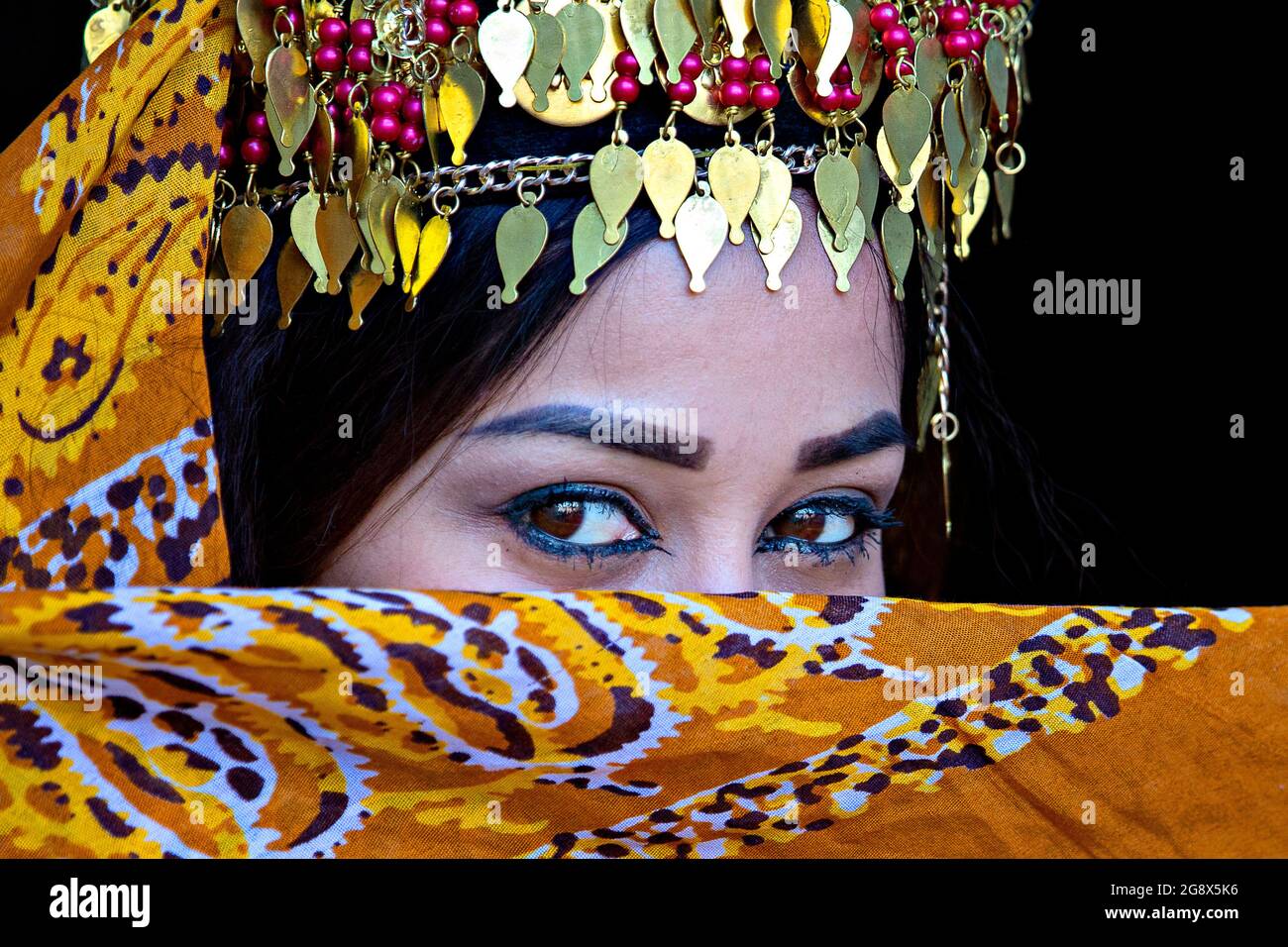 Portrait of Uzbek woman in traditional clothes in Khiva, Uzbekistan Stock Photo