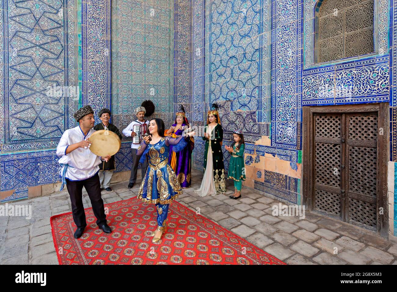Khorezmian musicians in local dress dance, in Khiva, Uzbekistan. Stock Photo