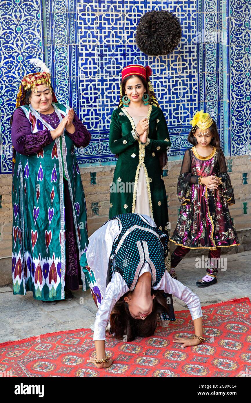 Khorezmian musicians in local dress dance, in Khiva, Uzbekistan. Stock Photo