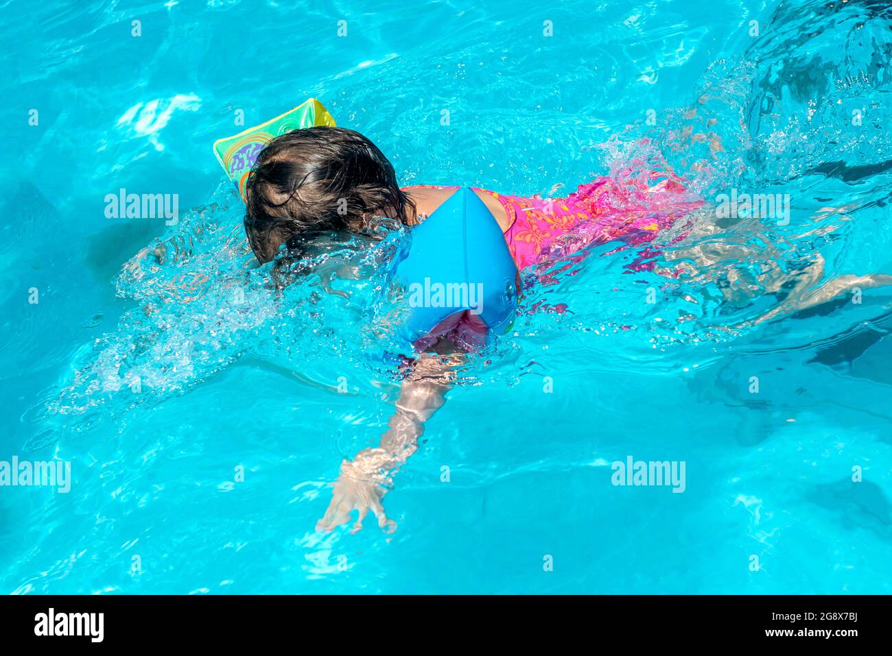 toddler alone diving in the swimming pool Stock Photo