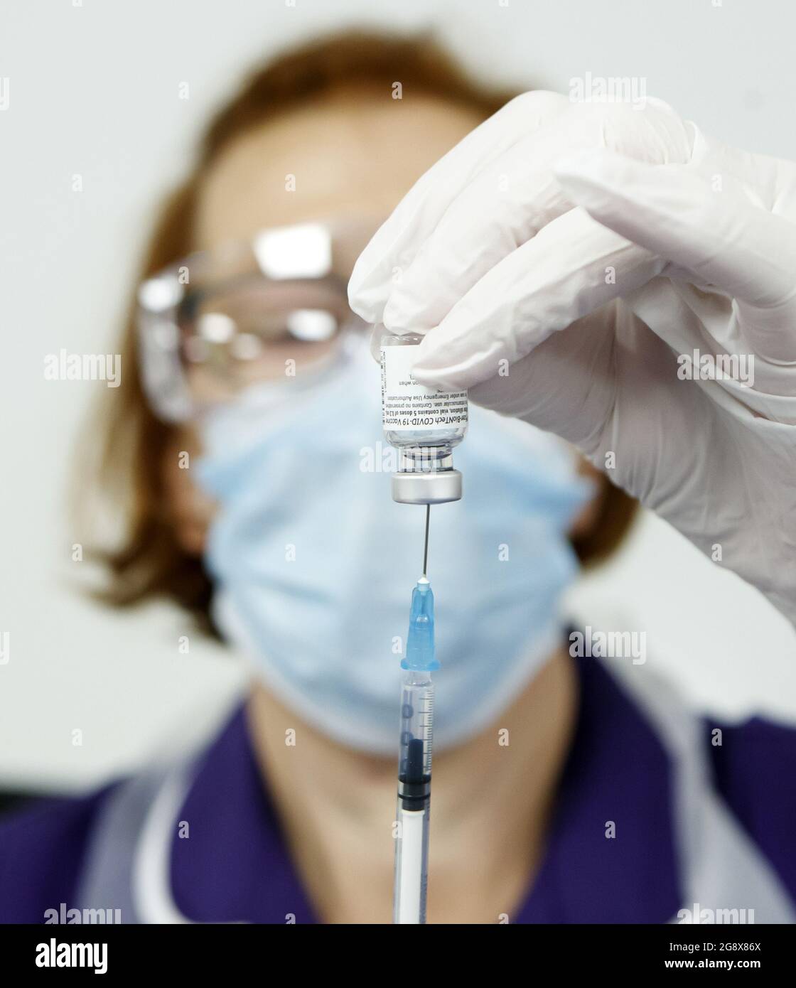 File photo dated 22/12/2020 of a nurse preparing a Pfizer/BioNTech Covid-19 vaccine. An eight-week gap between the first and second doses of the Pfizer/BioNTech Covid-19 vaccine is a 'sweet spot' when it comes to generating strong immune response while protecting the UK population against the Delta variant of coronavirus, scientists have said. Issue date: Friday July 23, 2021. Stock Photo