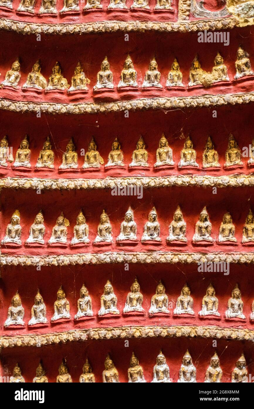 Old temple with Buddhas statues and religious carving on limestone rock in sacred Kaw Goon cave near Hpa-An in Myanmar Stock Photo