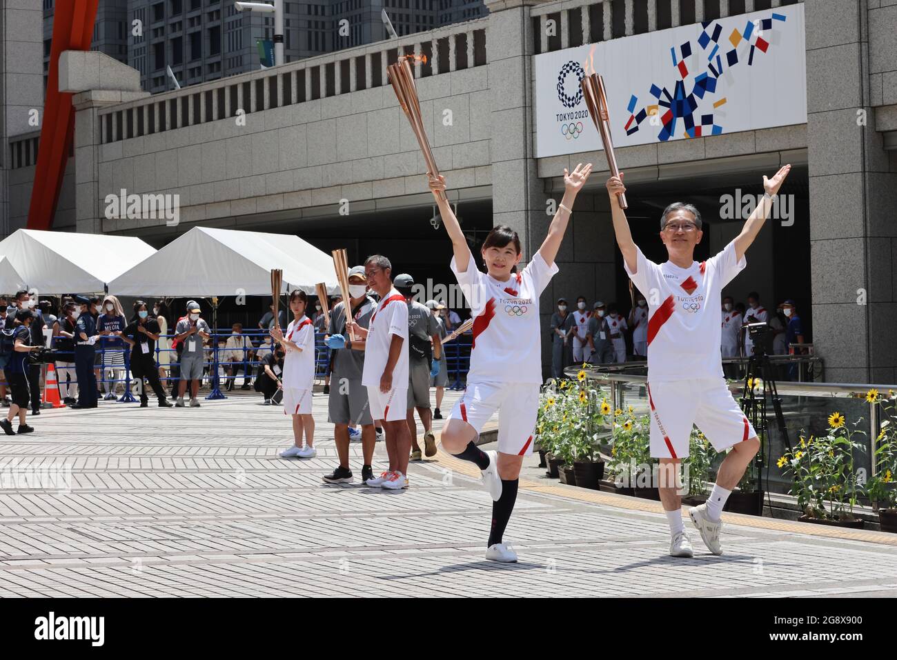 Tokyo, Japan. 23rd July, 2021. Torchbearers pose for a photo with the Olympic flame.Arrival Ceremony for Tokyo 2020 Olympic Torch Relay at the Tokyo Metropolitan Government Building in Shinjuku. (Photo by Stanislav Kogiku/SOPA Images/Sipa USA) Credit: Sipa US/Alamy Live News Stock Photo
