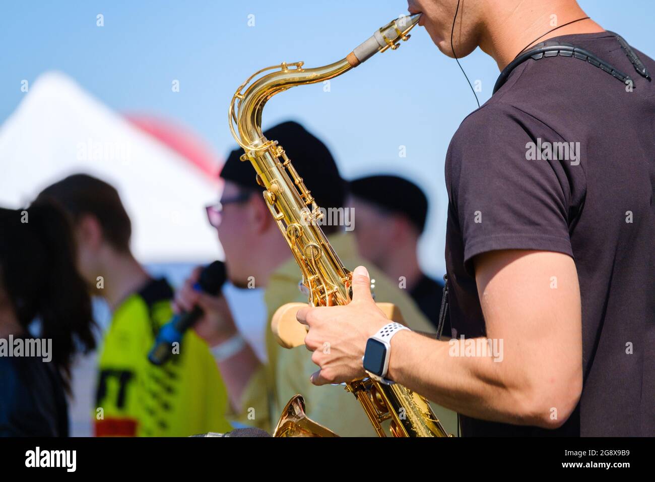 Crop man playing saxophone on street Stock Photo