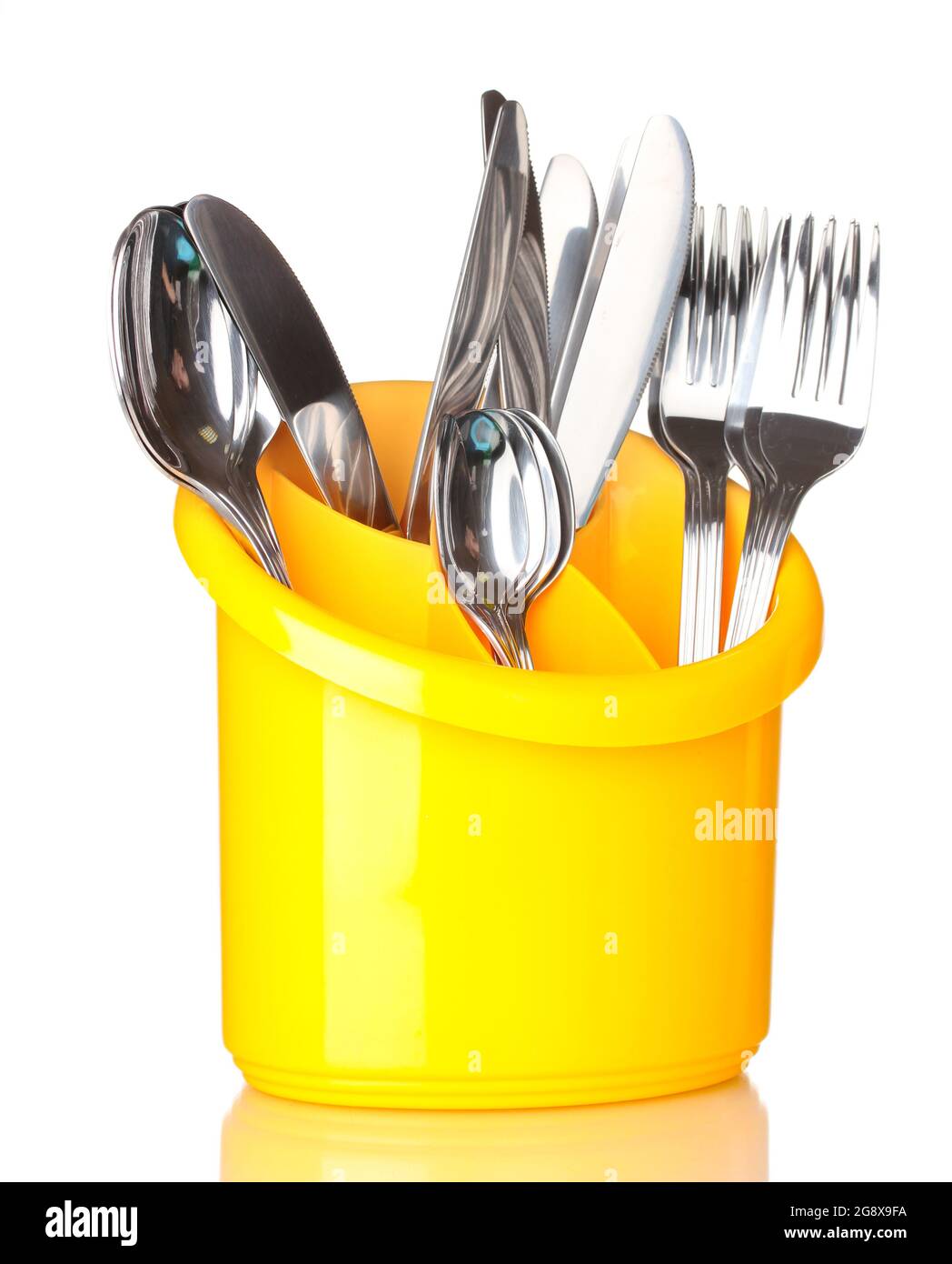 Kitchen cutlery, knives, forks and spoons in yellow stand isolated on