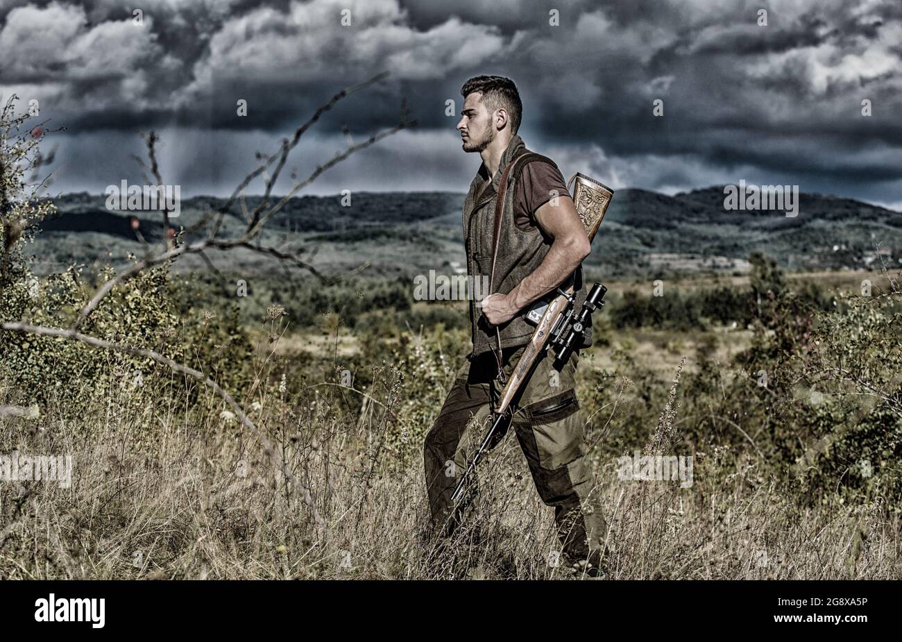 Regulation of hunting. Hunter rifle gun stand top of mountain. Guy