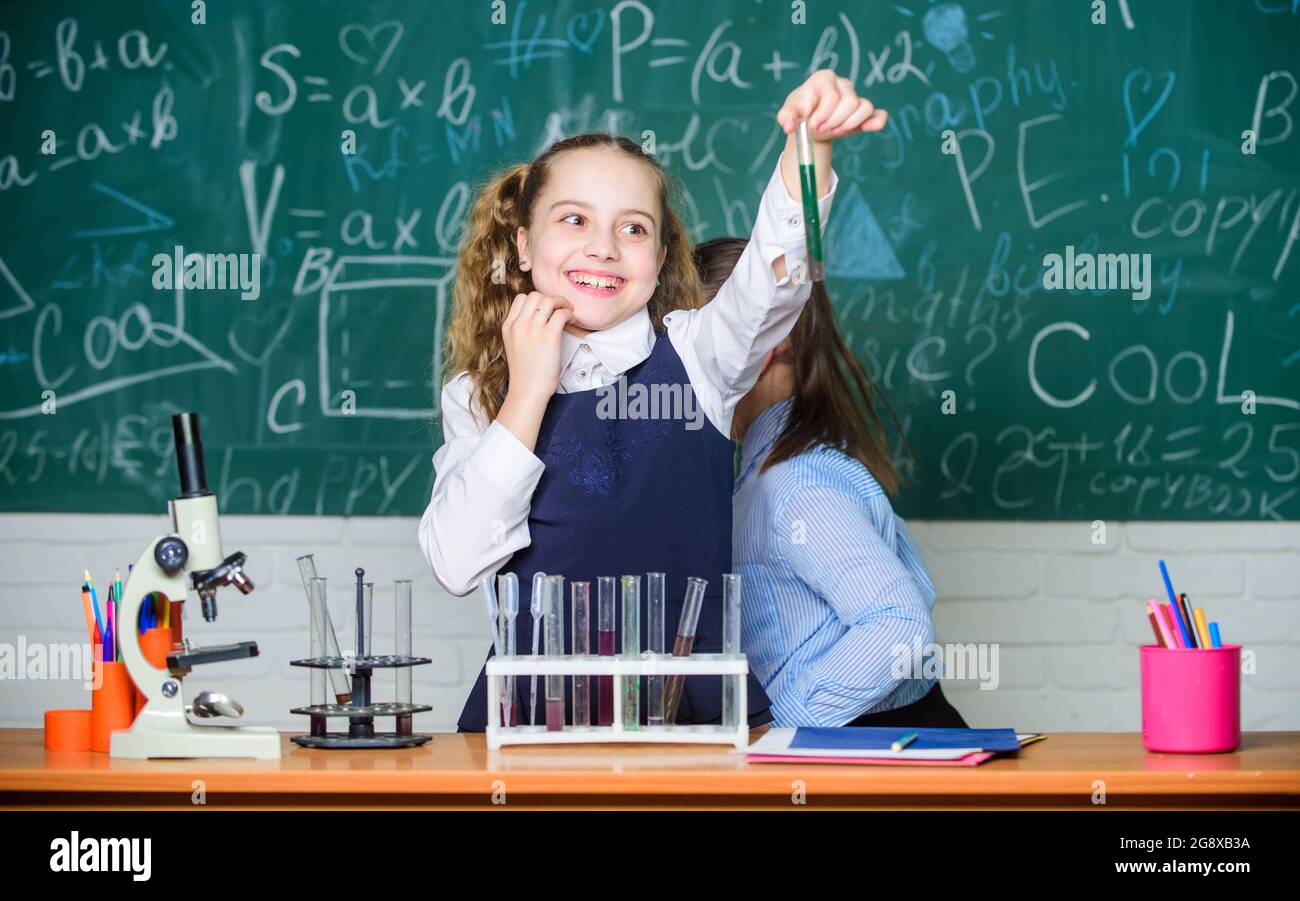 students doing biology experiments with microscope in lab. Happy children. Biology lesson