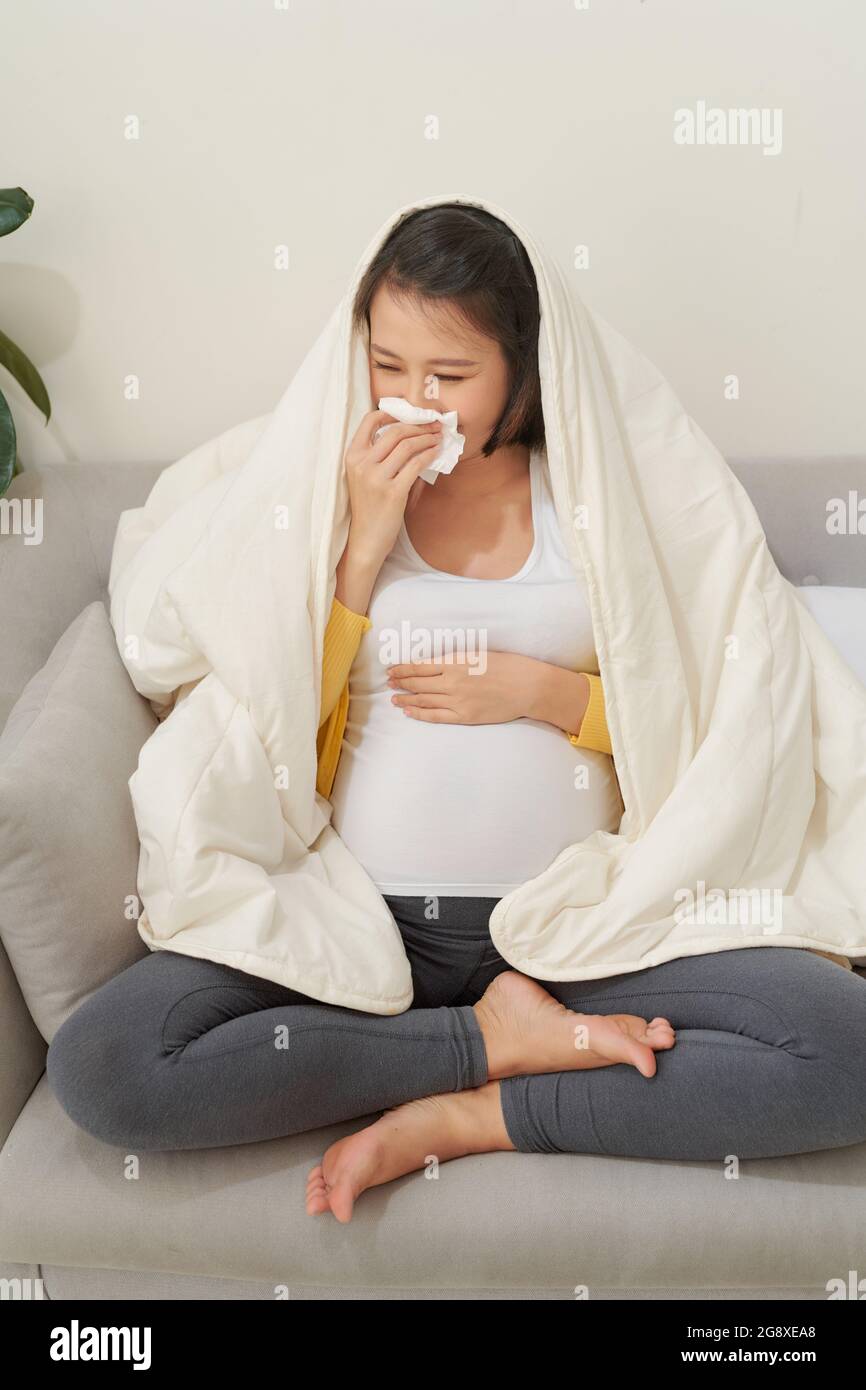 Pregnancy And Cold. Sick Pregnant Lady Blowing Nose In Tissue Feeling