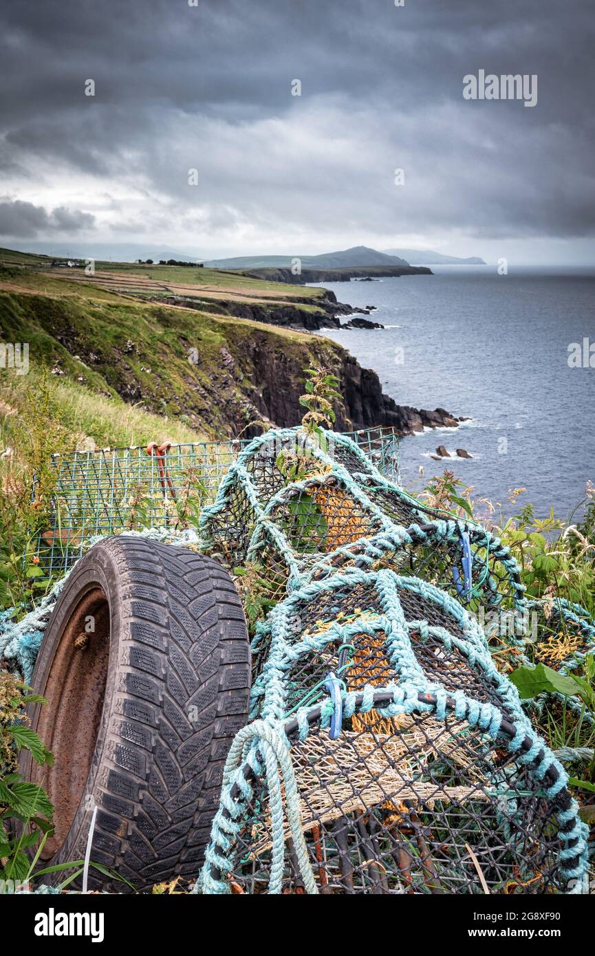 Lobster pots on the edge of sea cliff in Dingle Ireland Stock Photo
