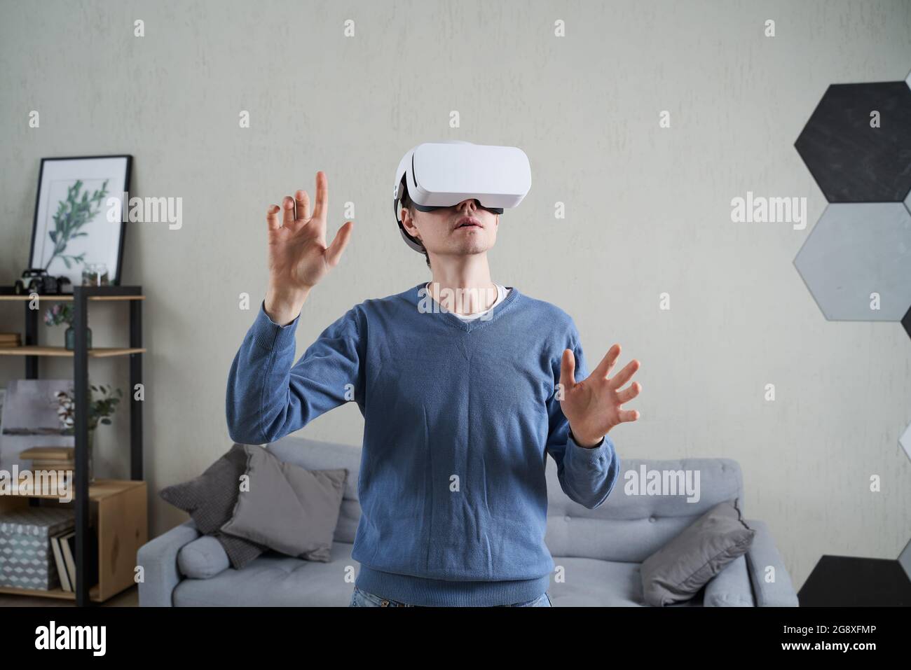 Man is using virtual reality headset. Concept of virtual reality, simulation, gaming and future technology. Stock Photo