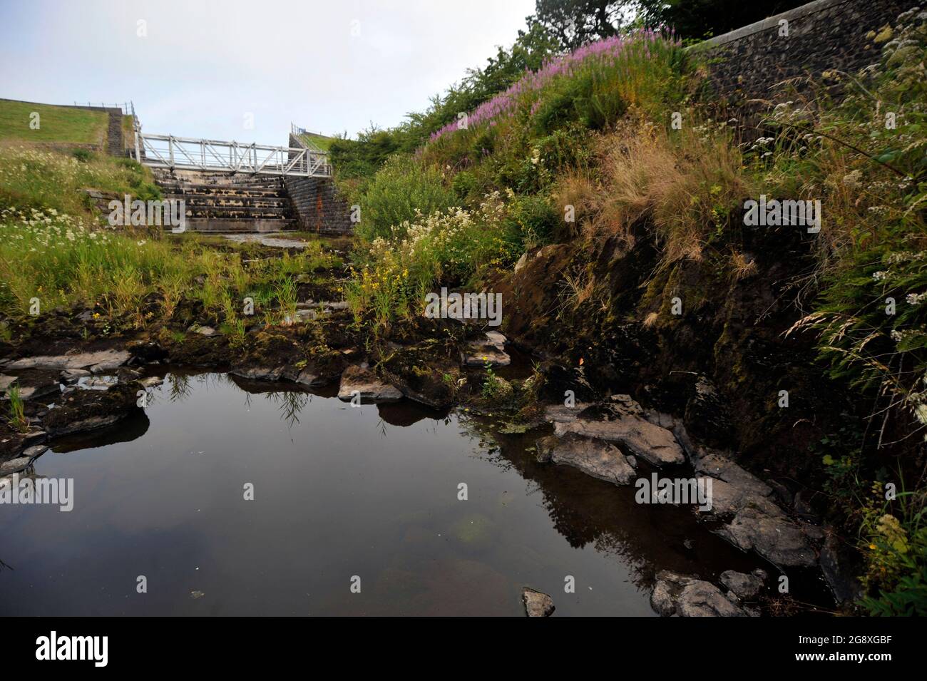 Unusually hot weather causes water levels to fall at Camphill reservoir, North Ayrshire, Scotland, the source for almost all of the areas fresh water. Stock Photo