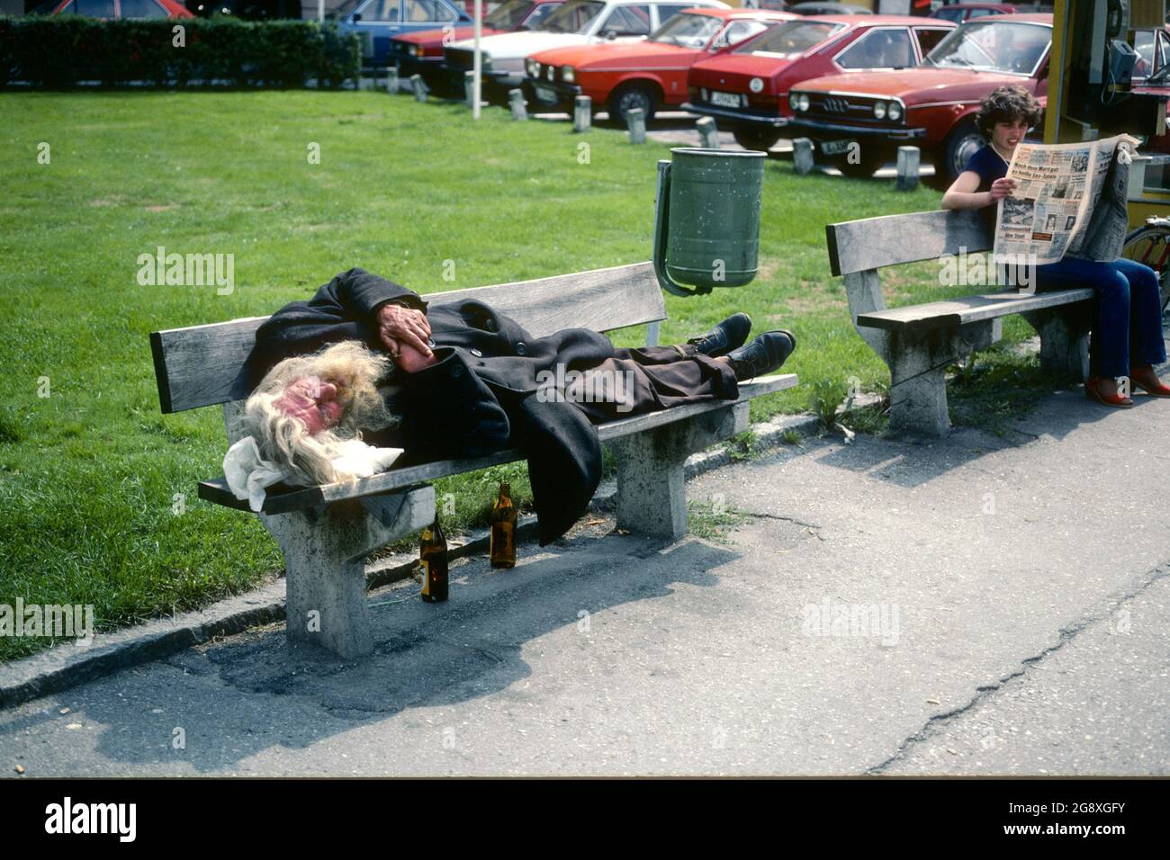 Homeless man asleep on a bench in 1981, Landshut, Bavaria, Germany Stock Photo