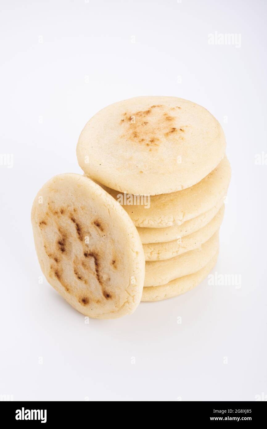 Stack of arepas made with corn flour on a white background, typical