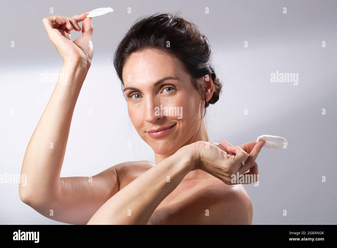 a woman having fun with a pair of cotton pads Stock Photo