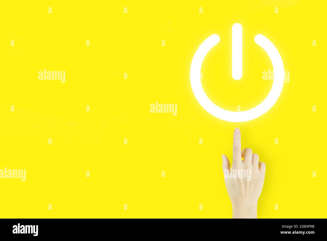 Young woman's hand finger pointing with hologram pressing button on virtual screen on yellow background. Start or shut down concept Power up concept Stock Photo