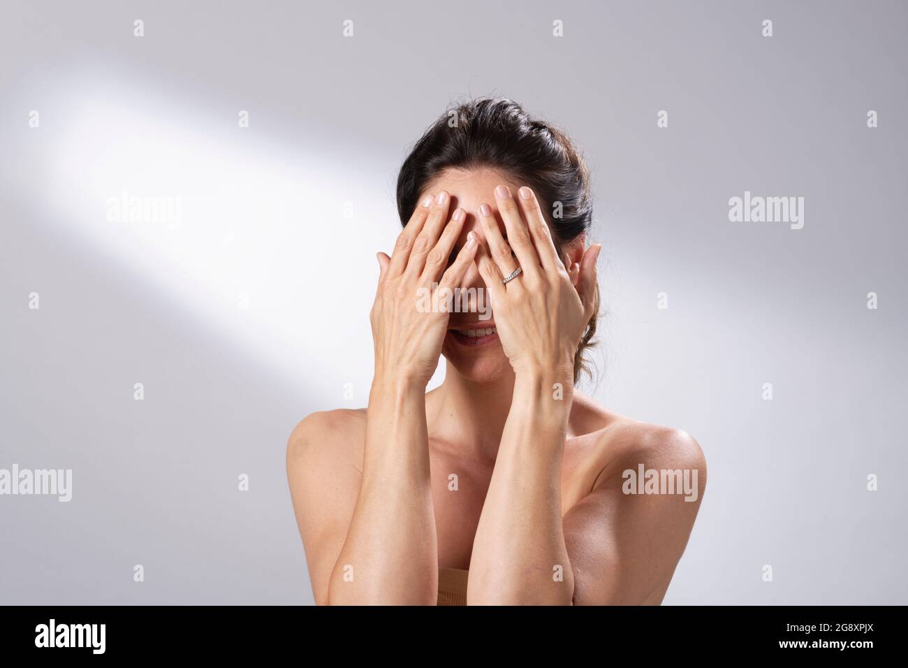 A woman's skincare regime. Hands and fingers on face and gently massage. Stock Photo