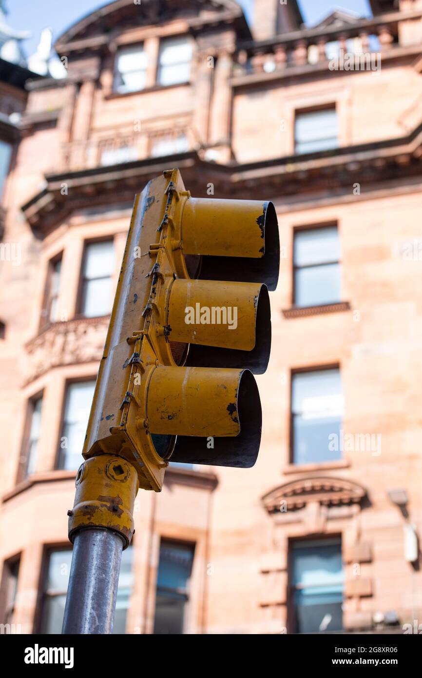 Glasgow, Scotland, UK. 22 July 2021.  PICTURED: The tell tale sign of the yellow American style traffic lights are the last to be removed. The deconstruction of the film set which was based in Glasgow’s City Centre St Vincent Street for the new Hollywood blockbuster movies Indiana Jones 5.  Rigger crews move in and take down all the American flags, bunting, shop signs and street furniture and pack it away into trucks. Each set piece is then catalogued and placed into storage. Glasgow returns to a more Scottish looking city after being 1950/1960s New York for the last 10 days of filming. Credit Stock Photo