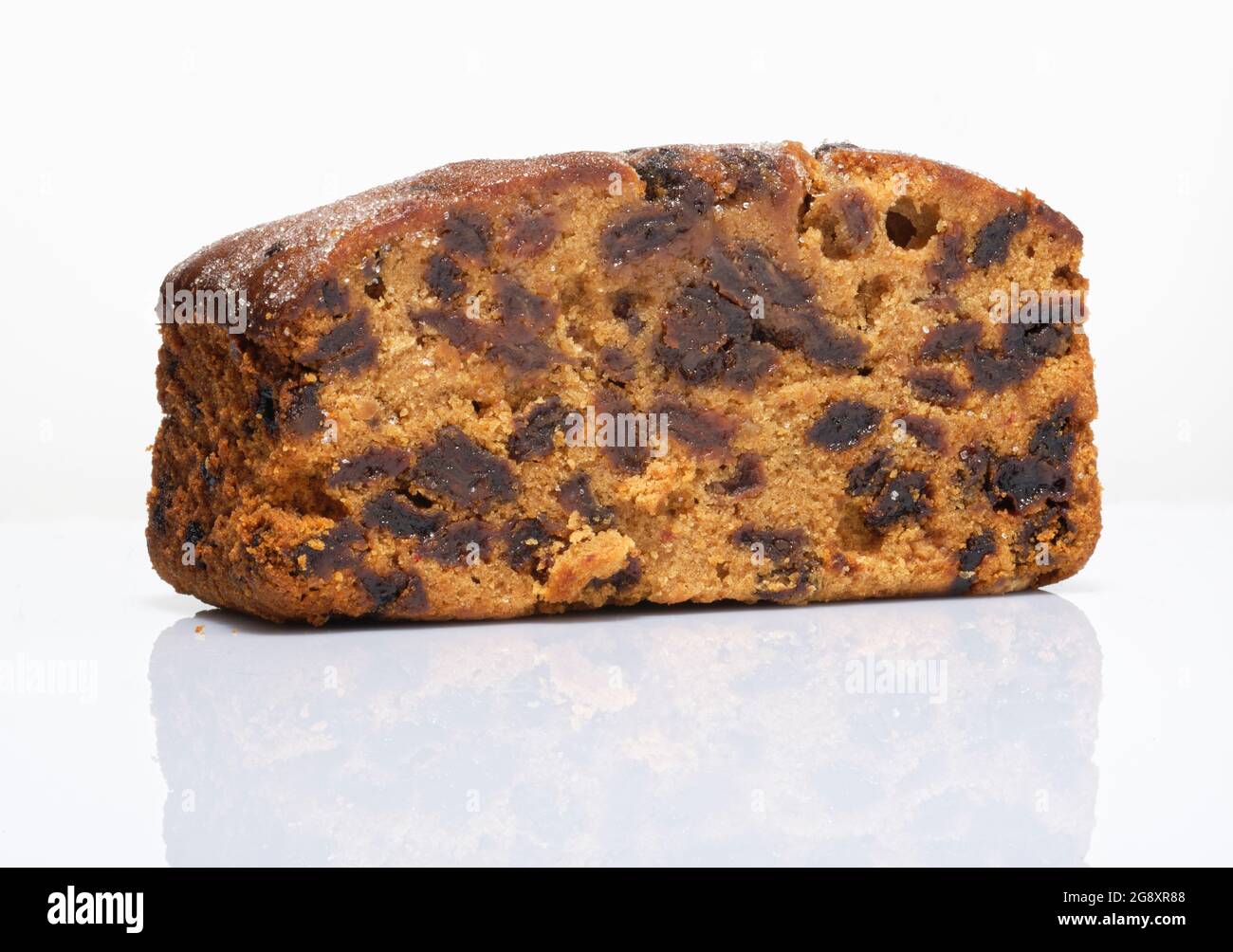 A small fruit cake. A mix of currants, raisins and other dried fruit with flour and egg and baked in an oven to make a moist fruit cake. Stock Photo