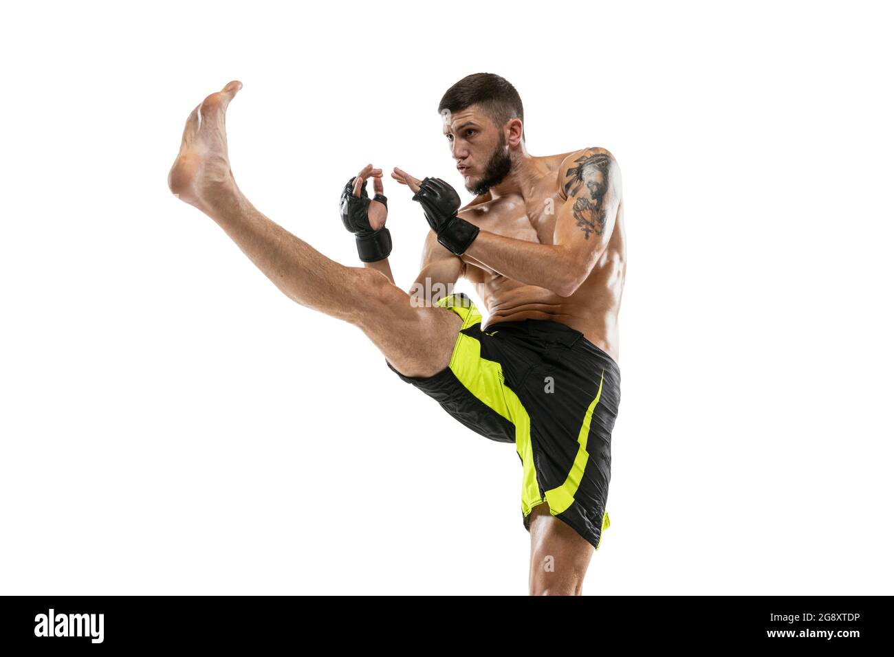 Professional male MMA boxer in motion isolated on white studio background. Fit muscular caucasian athlete fighting. Stock Photo