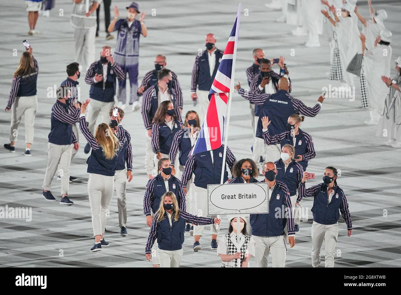 Tokyo, Japan. 23rd July, 2021. Olympics: Opening ceremony at the Olympic Stadium. The Great Britain team with flag bearers sailor Hannah Mills and rower Mohamed Sbihi enter the stadium. Credit: Michael Kappeler/dpa/Alamy Live News Stock Photo