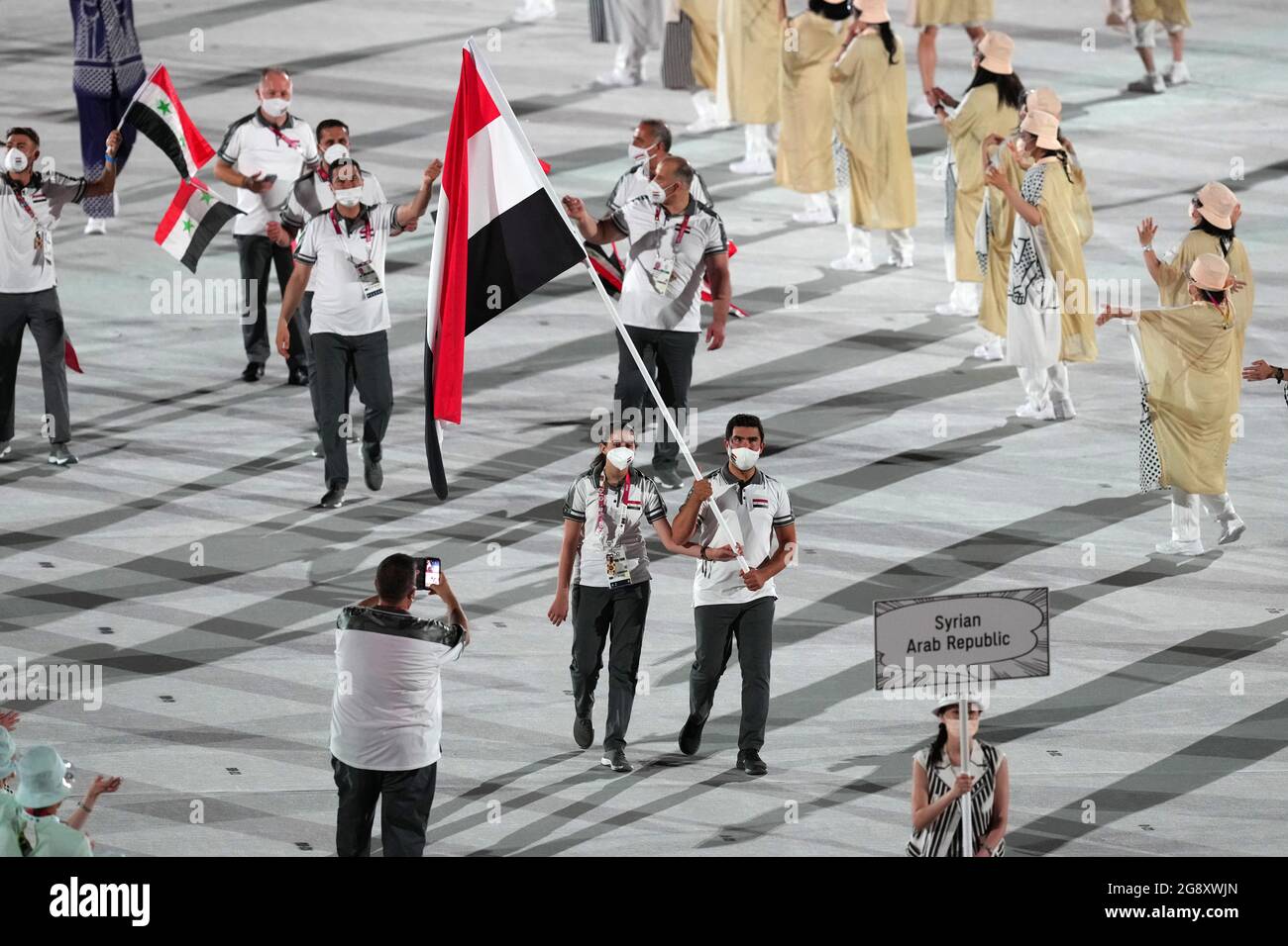 Syrian Arab Republic flagbearers Hend Zaza and Ahmad Saber Hamcho lead out the team during the opening ceremony of the Tokyo 2020 Olympic Games at the Olympic Stadium in Japan. Picture date: Friday July 23, 2021. Stock Photo