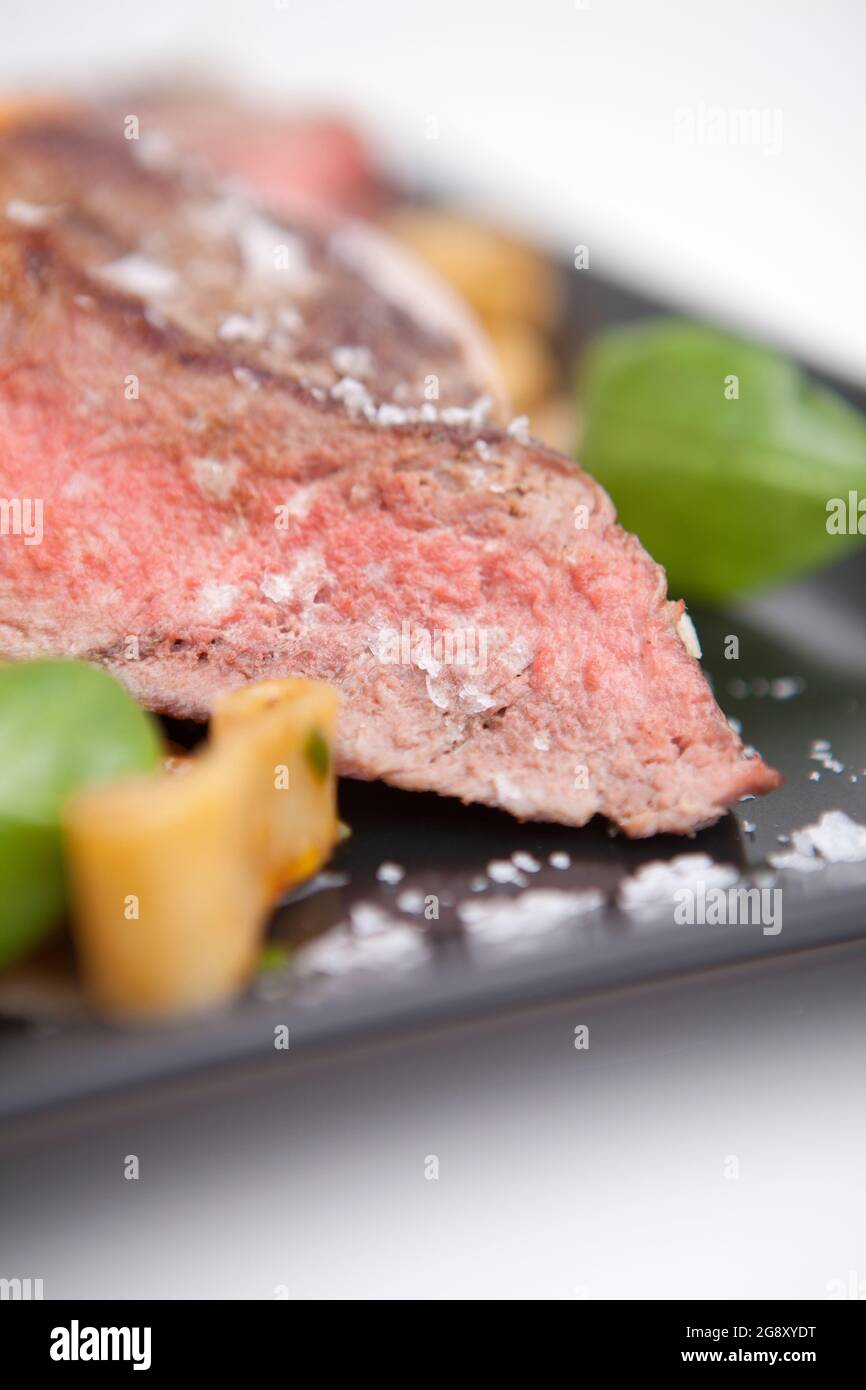 Rib-eye steak with penne pasta. Meat, gourmet lunch English cuisine. Stock Photo