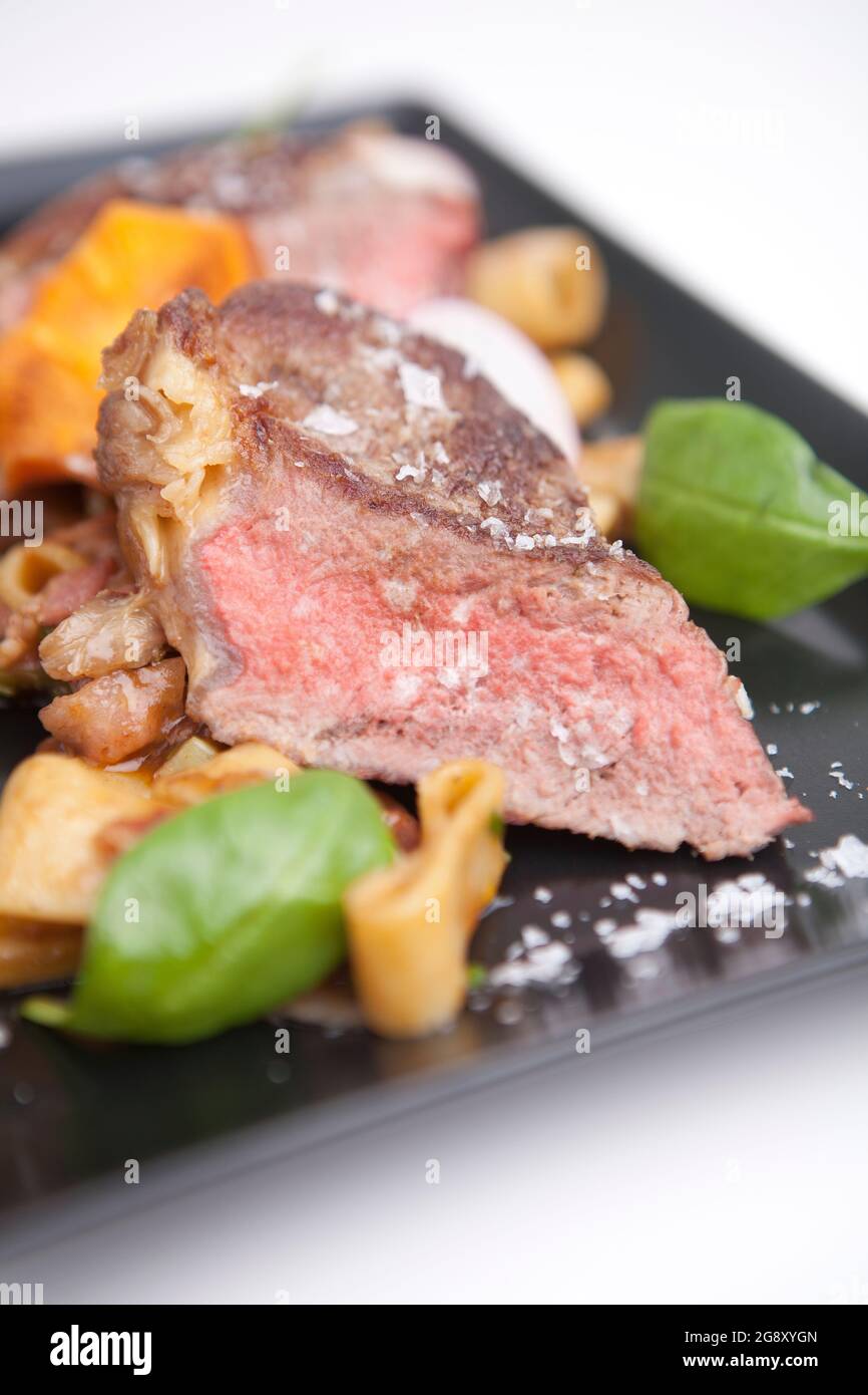 Ribeye steak with penne pasta. Meat, gourmet lunch English cuisine