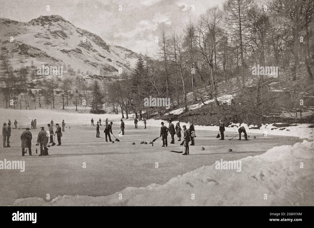 A late 19th century view of men playing curling in Birnam, a village in Perth and Kinross, Scotland. A favourite game in Scotland, curling is a sport in which two teams, each with four players, take turns sliding heavy, polished granite stones, across the ice toward a circular target marked on the ice. The path of the rock may be further influenced by two sweepers with brooms or brushes, who a sweep the ice in front of the stone decreasing the friction, which makes the stone travel a straighter path (with less 'curl') and a longer distance. Stock Photo