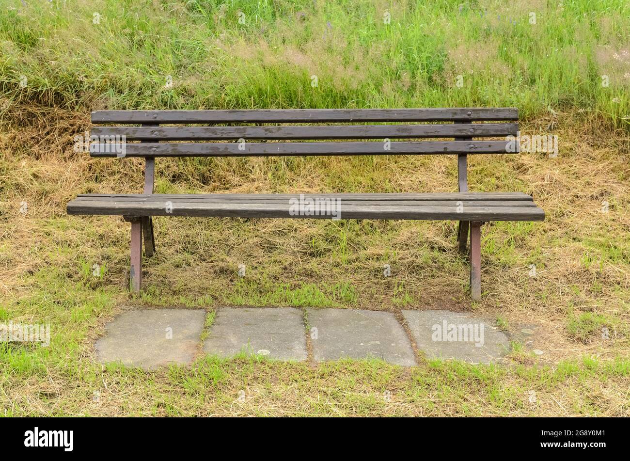 Wooden park bench in the rural countryside Stock Photo