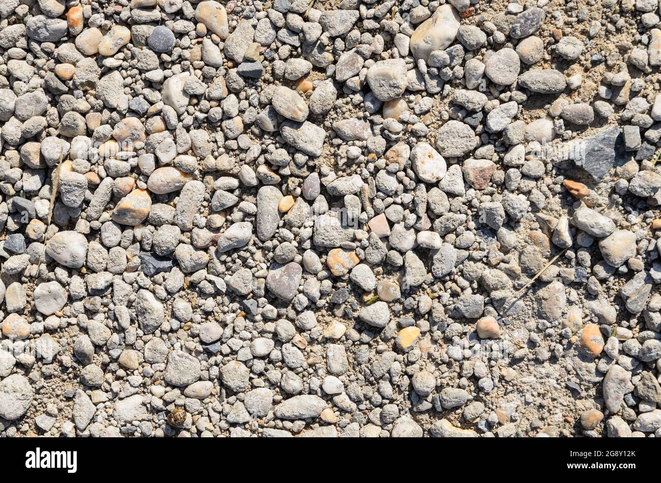 Small grey pebble stones on the ground Stock Photo