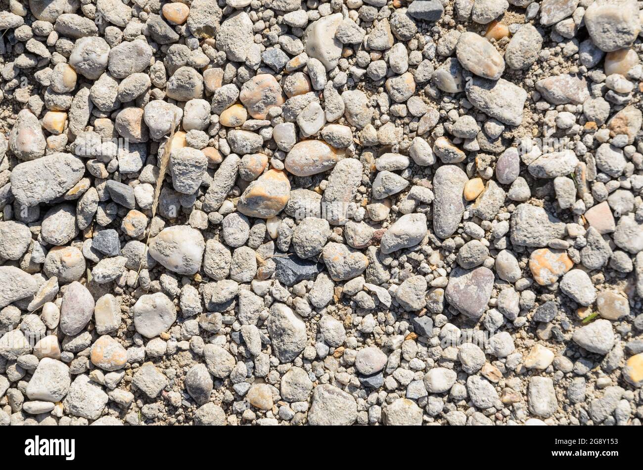 Small grey pebble stones on the ground Stock Photo