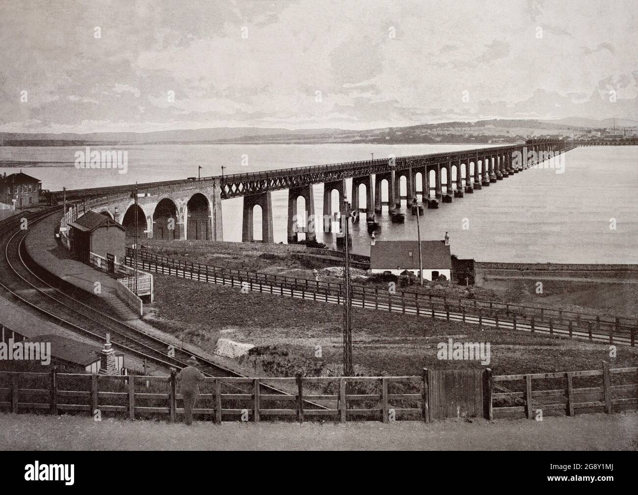 A late 19th century view of the Tay Bridge that carries the railway across the Firth of Tay in Scotland between Dundee and the suburb of Wormit in Fife. Its span is 2.75 miles (4.43 kilometres). Plans for a bridge over the Tay to replace the train ferry service emerged in 1854, but the first Tay Bridge did not open until 1878. The bridge suddenly collapsed in high winds the following year. It was replaced by the second bridge (pictured) constructed of iron and steel with a double-track parallel to the remains of the first bridge. Work commenced in 1883 and the bridge was opened in 1887. Stock Photo