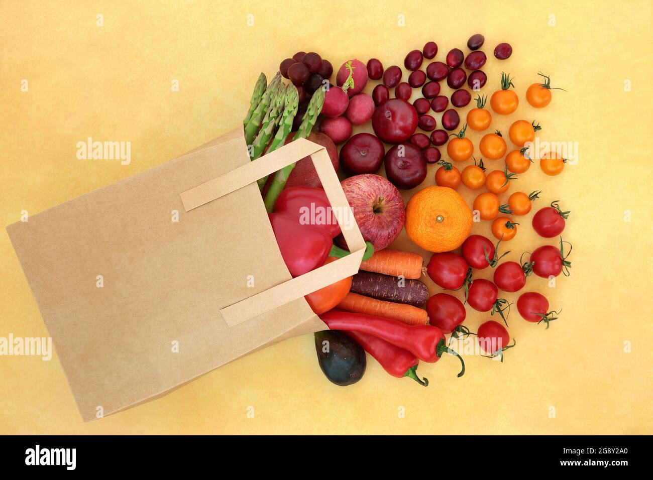 Grocery shopping fruit and vegetables in a brown paper bag, high in ...