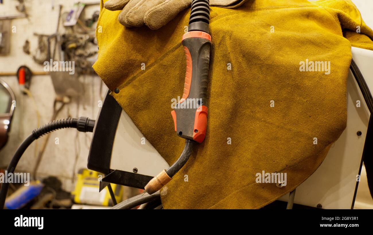 A MIG Welding Torch and MIG Welder Along With Protective Clothing Stock Photo