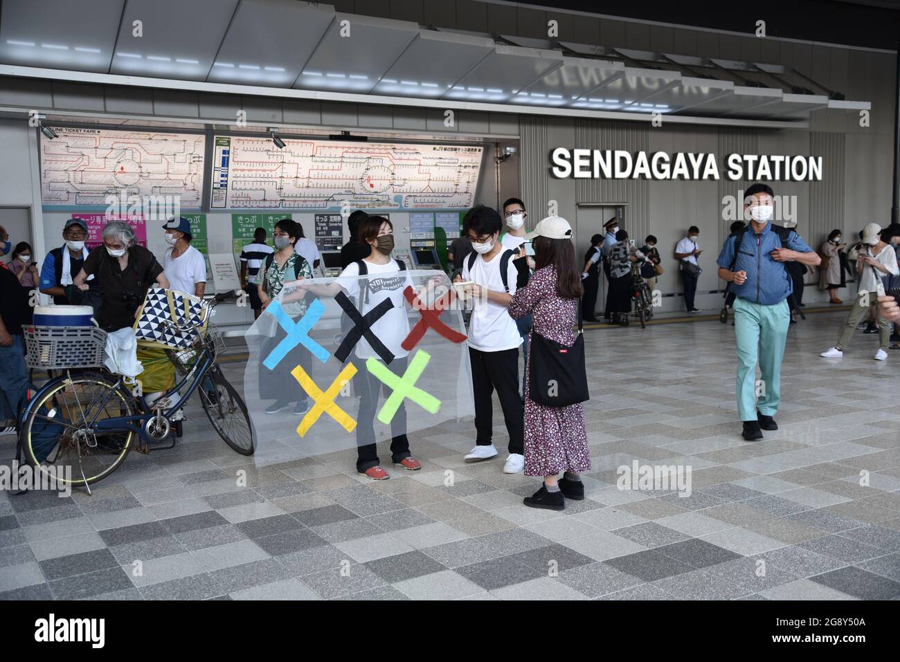 Tokyo, Japan - July 23, 2021 : A protester holding an sign, a demonstration to Stop Tokyo Olympics 2020 Stock Photo