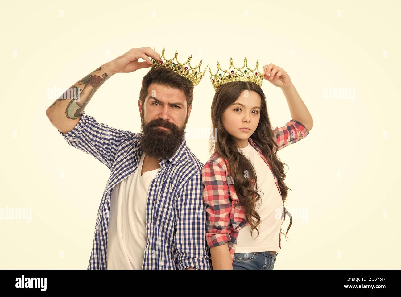 Are you going to prom. Prom king and young queen. Small child and bearded man hold prom crowns. Coronation party. Holiday celebration. Pride and glory Stock Photo