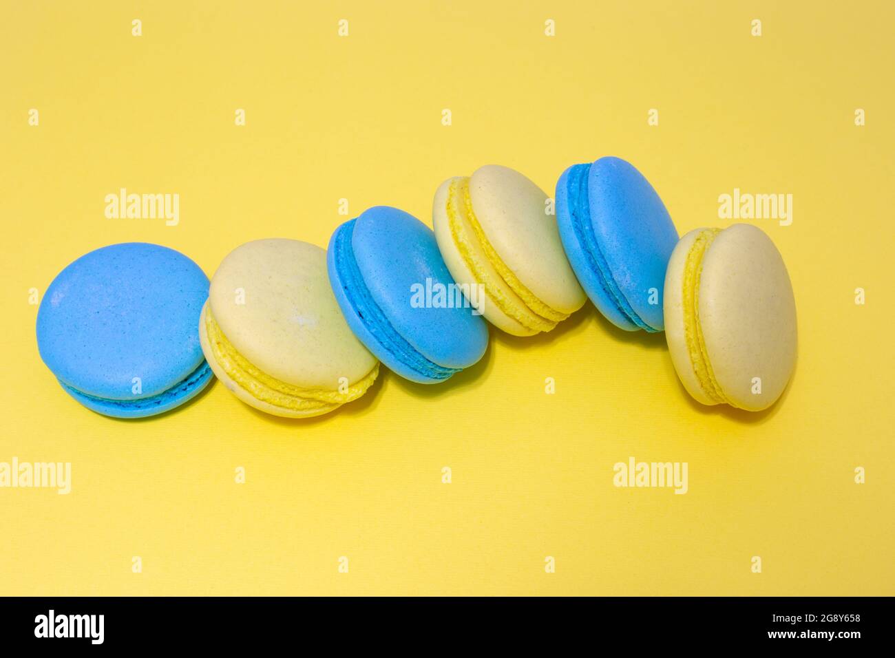 macaroni cookies lies on a yellow background, sweet pastries Stock Photo