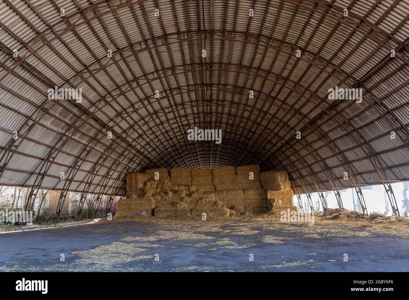 Large hangar for storing straw or hay. Cover for storage. Dry hay in