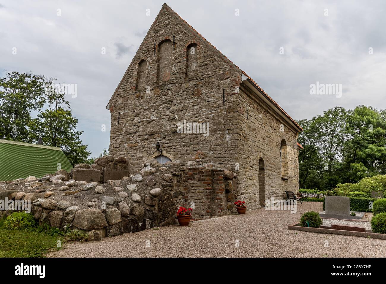 aged stone church from the early 12th century in a rural graveyard, Borrie, Sweden, July 16, 2021 Stock Photo