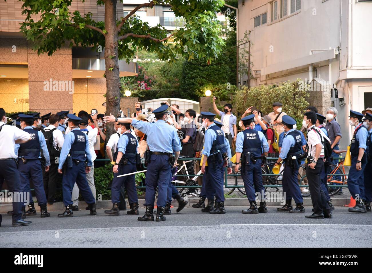 Tokyo, Japan - July 23, 2021 : Police officers guard street around Tokyo Stadium from protesters on Tokyo Olympics 2020 Stock Photo